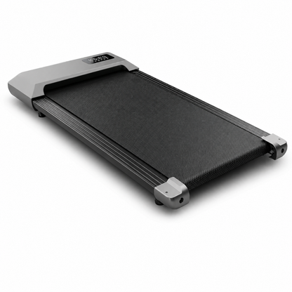 Understride under-desk walking pad treadmill on a clean white studio background, slim charcoal running belt and LED display