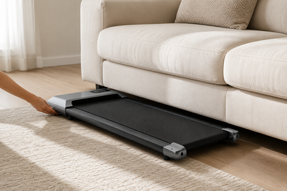 Slim Understride walking pad being rolled into storage under a sofa